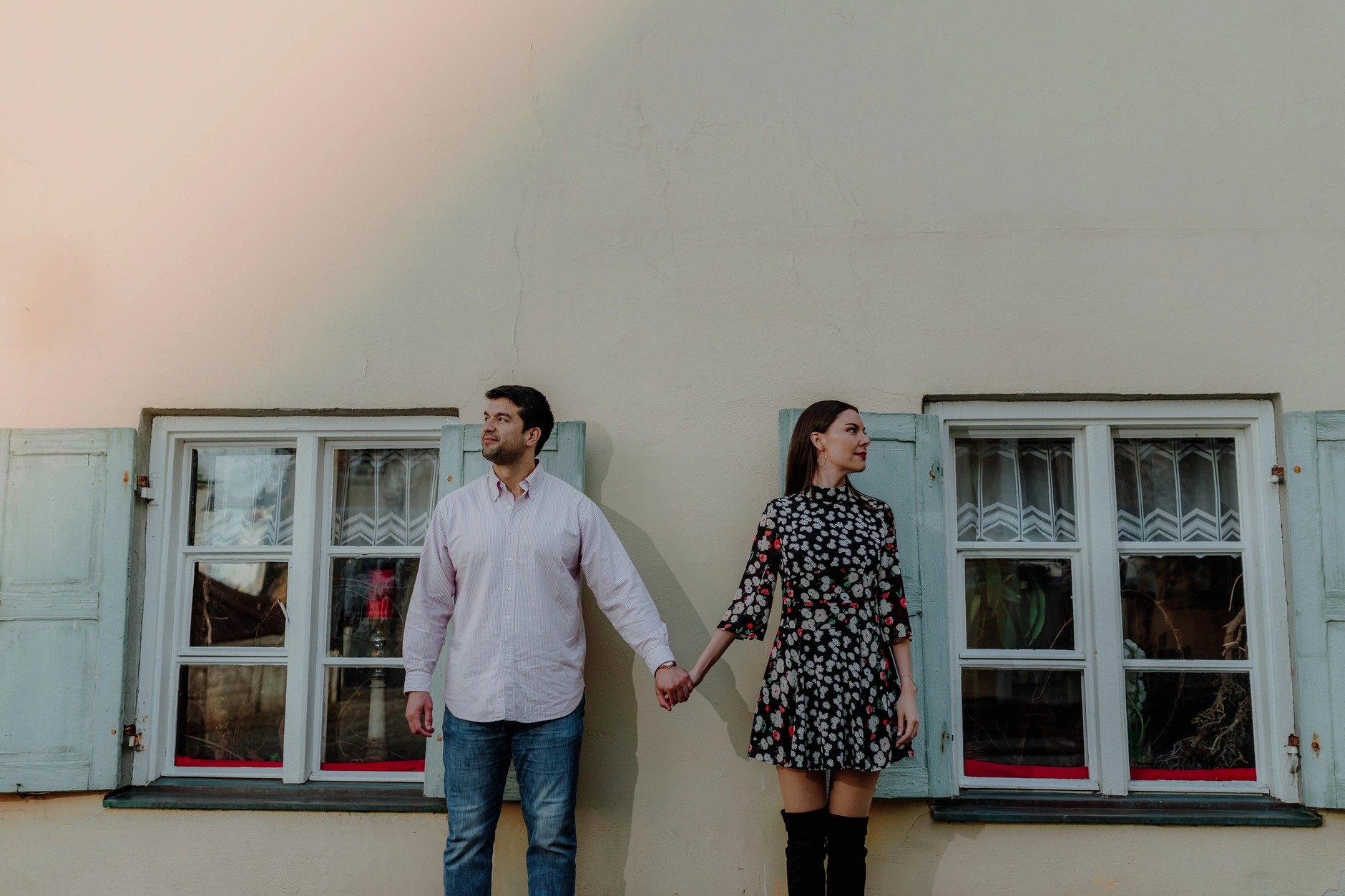 Couple standing by house windows in Wolfratshausen old town