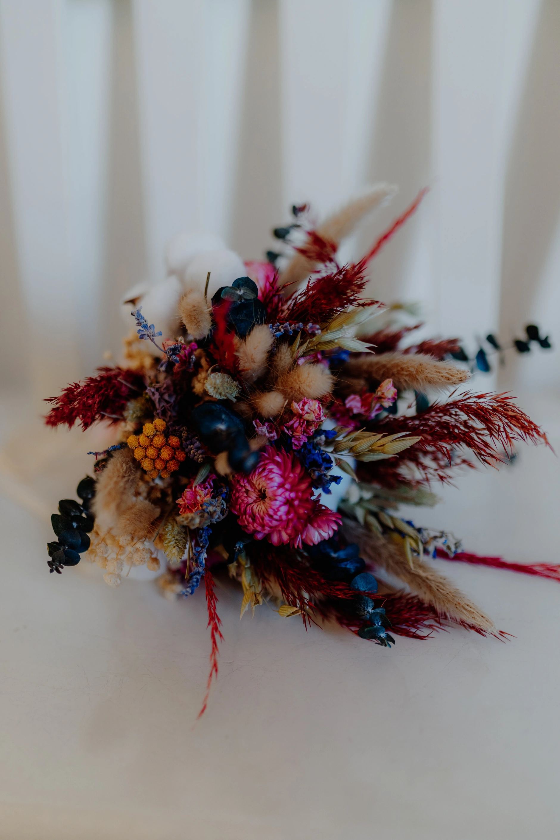 Africa and Yussuf, colorful bridal bouquet on a white chair at Schwabing Registry Office