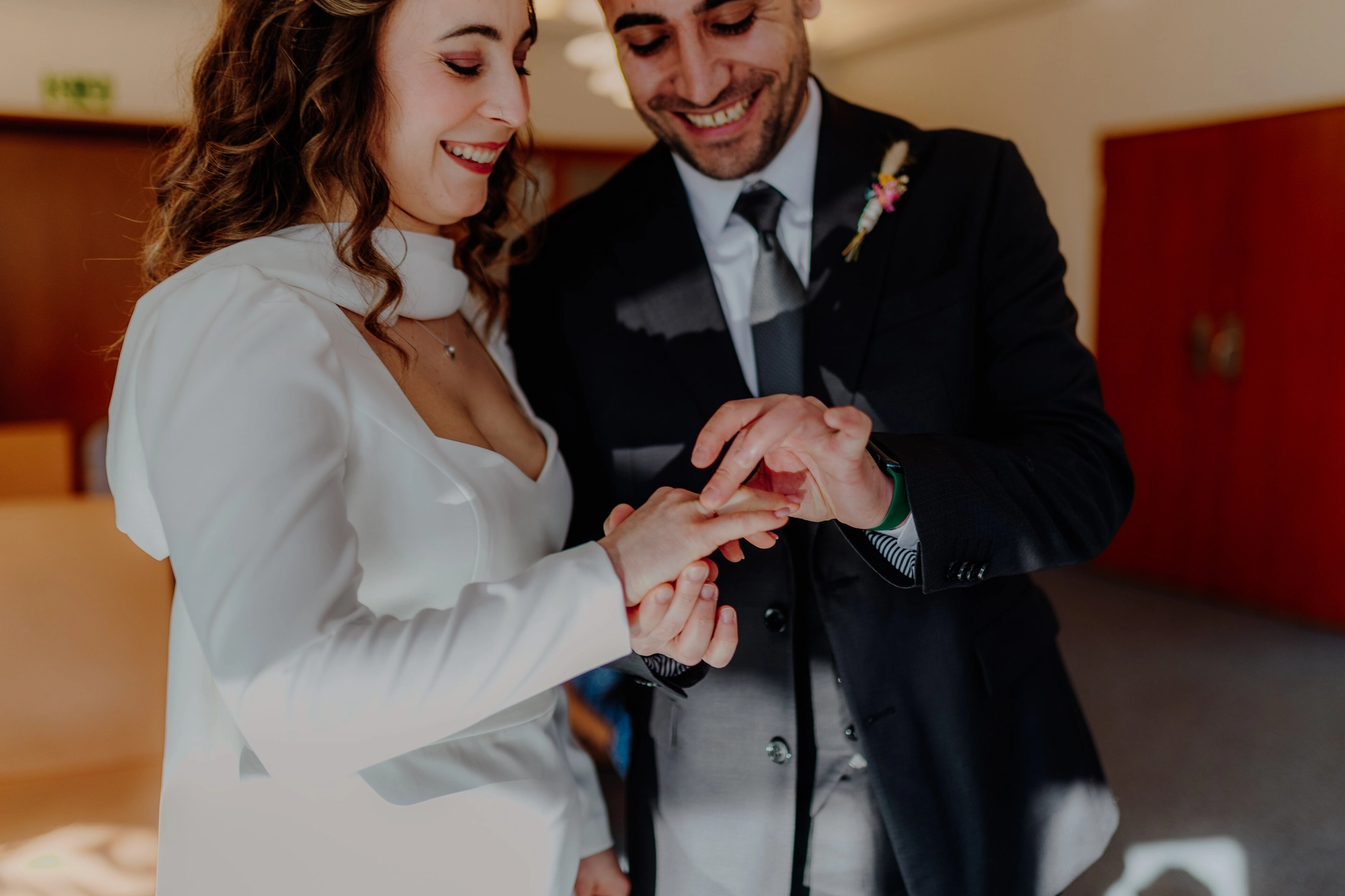 Africa and Yussuf, bride signing the marriage register with bouquet in hand