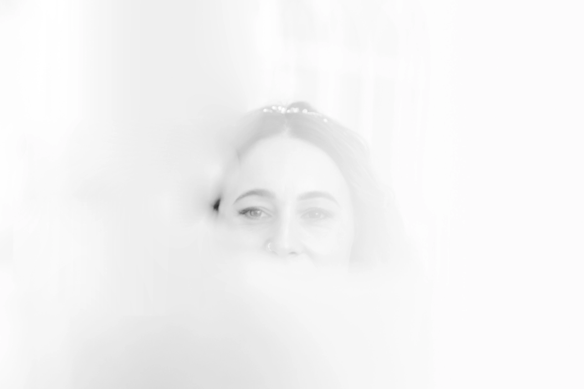 Africa and Yussuf, soft-focus portrait of the bride in window light at the registry office