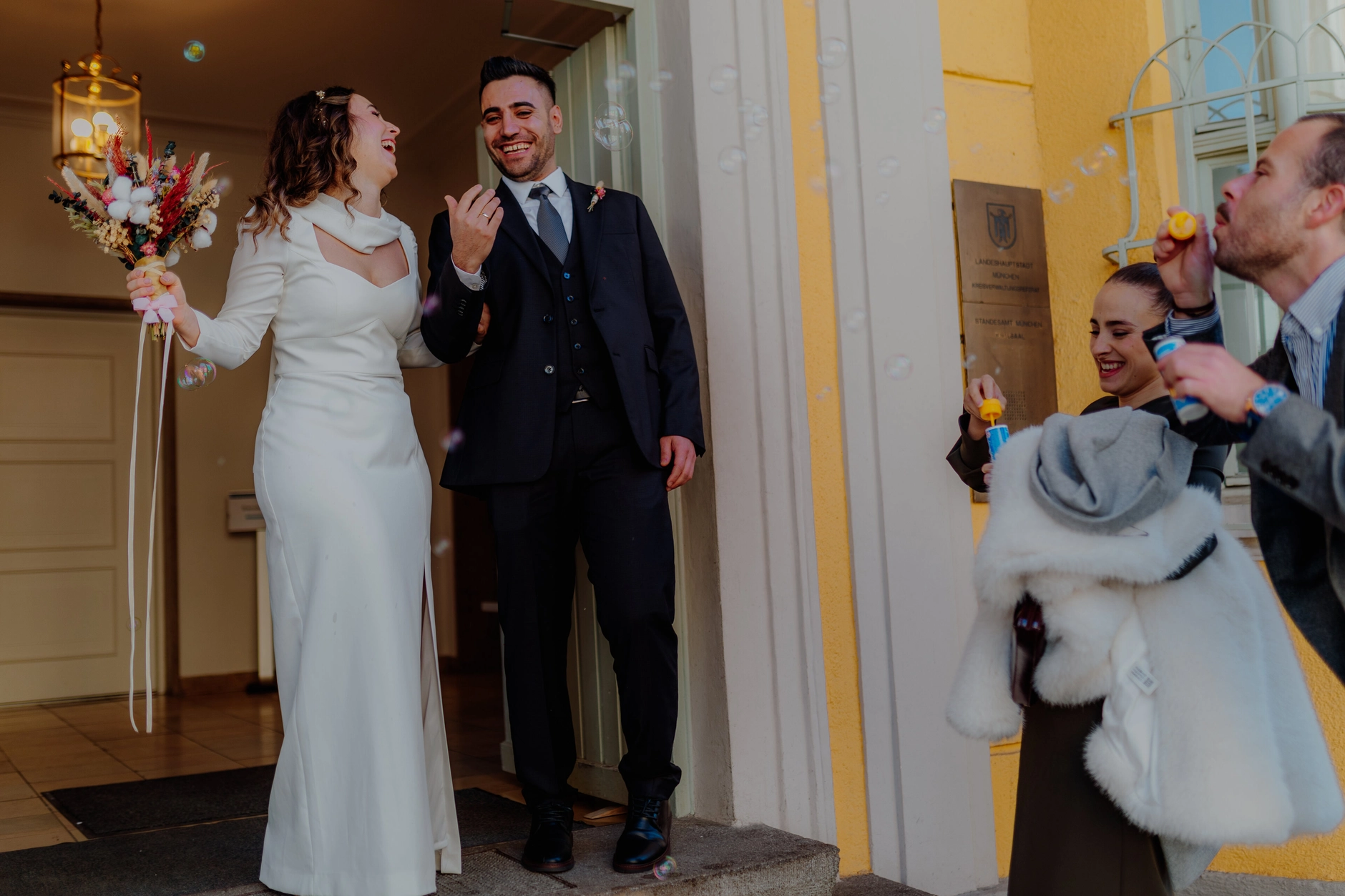 Africa and Yussuf leaving Schwabing Registry Office while guests cheer