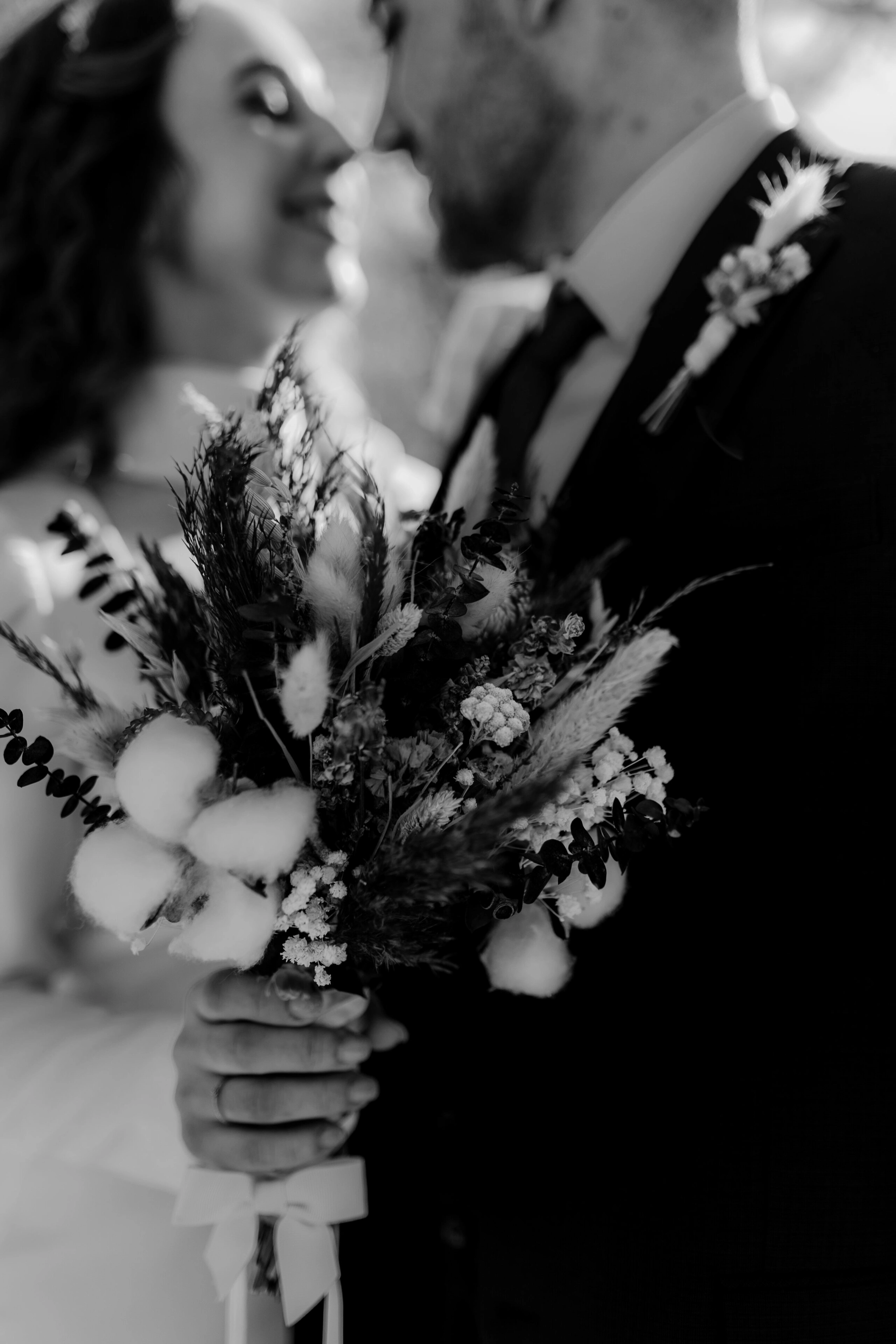 Africa and Yussuf, black-and-white close-up of the bridal bouquet outdoors