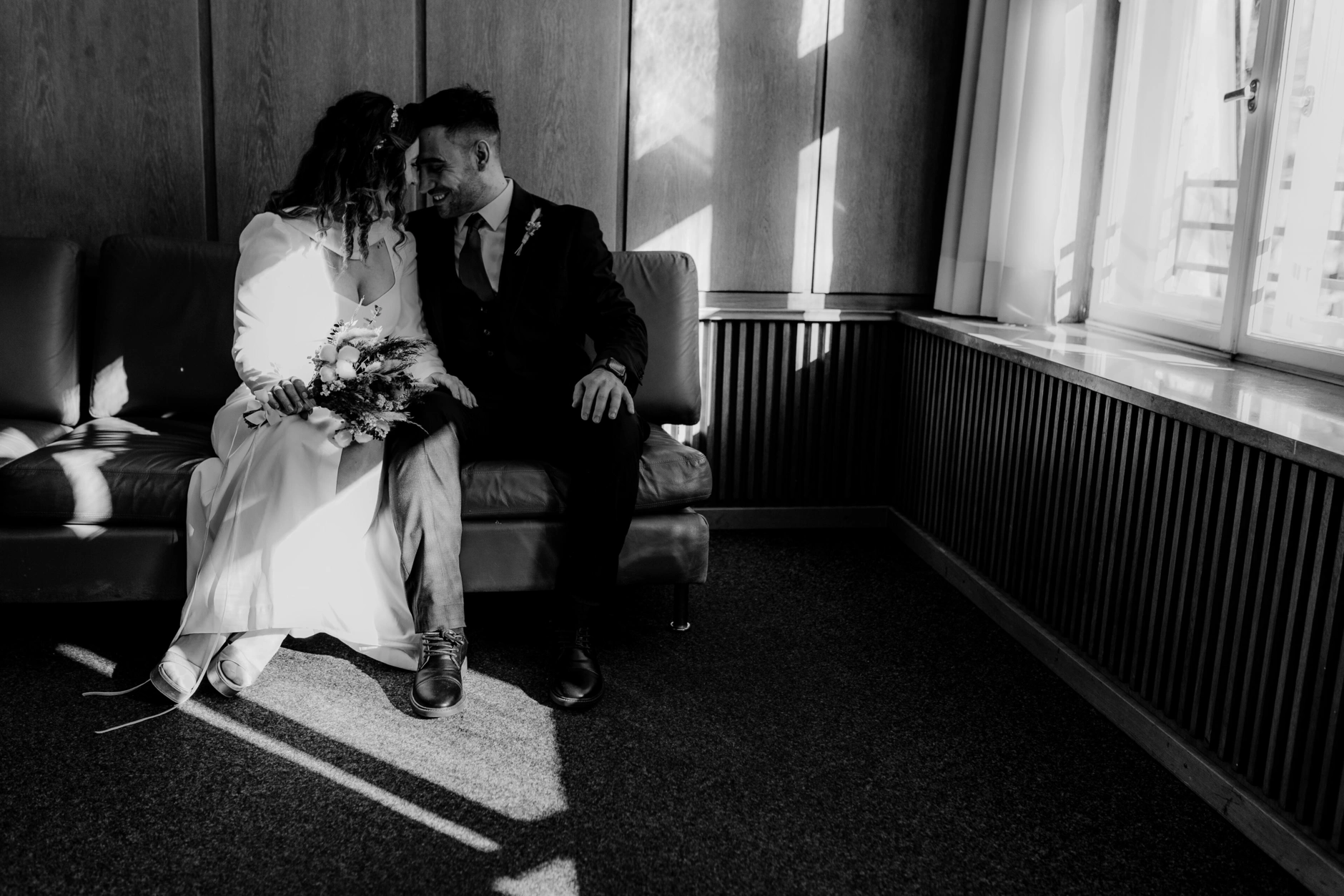 Africa and Yussuf, black-and-white portrait seated together by the window
