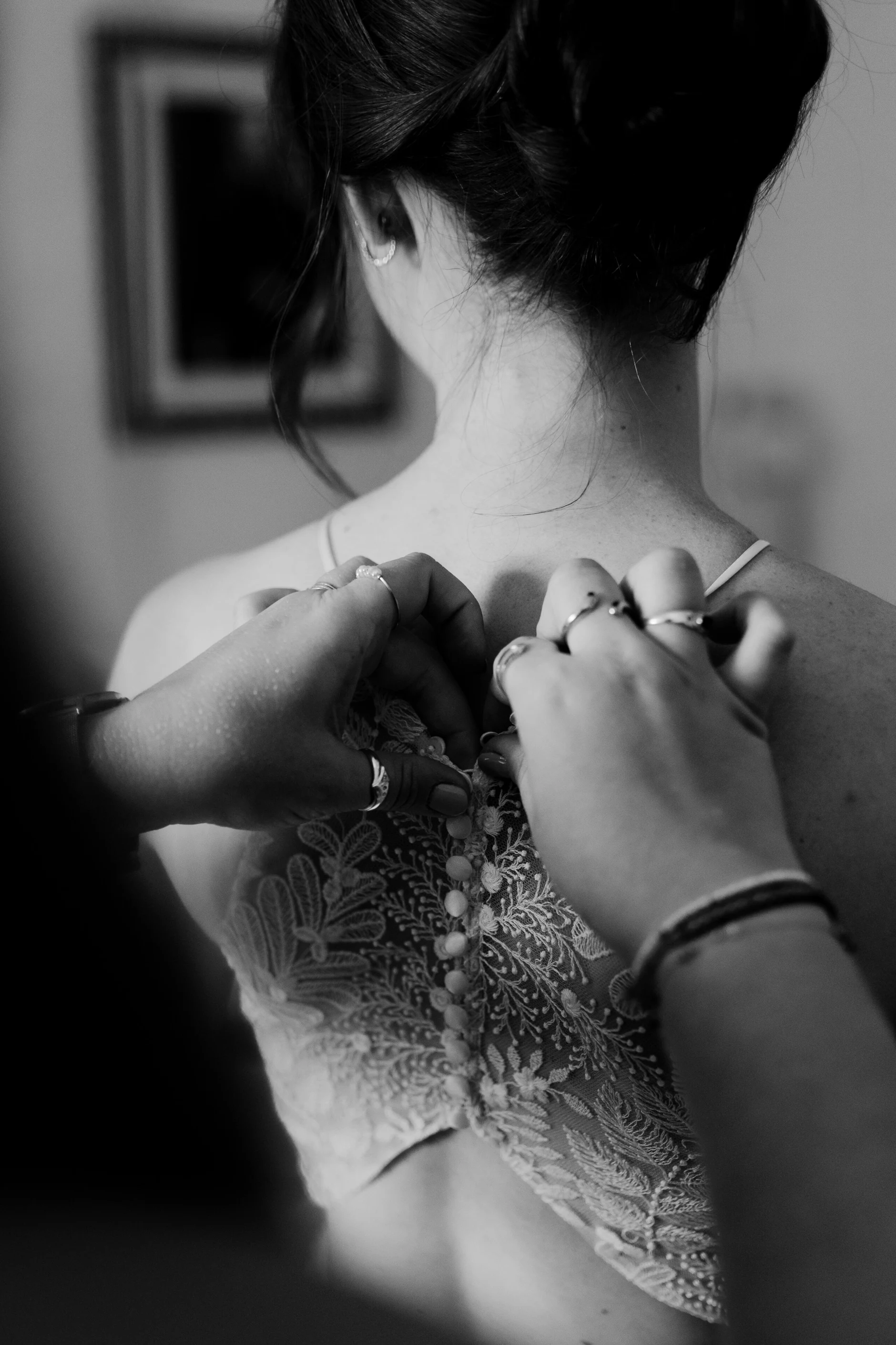 Hands lacing the corset back of the wedding dress – bridal preparation, Burg Abenberg castle Bavaria